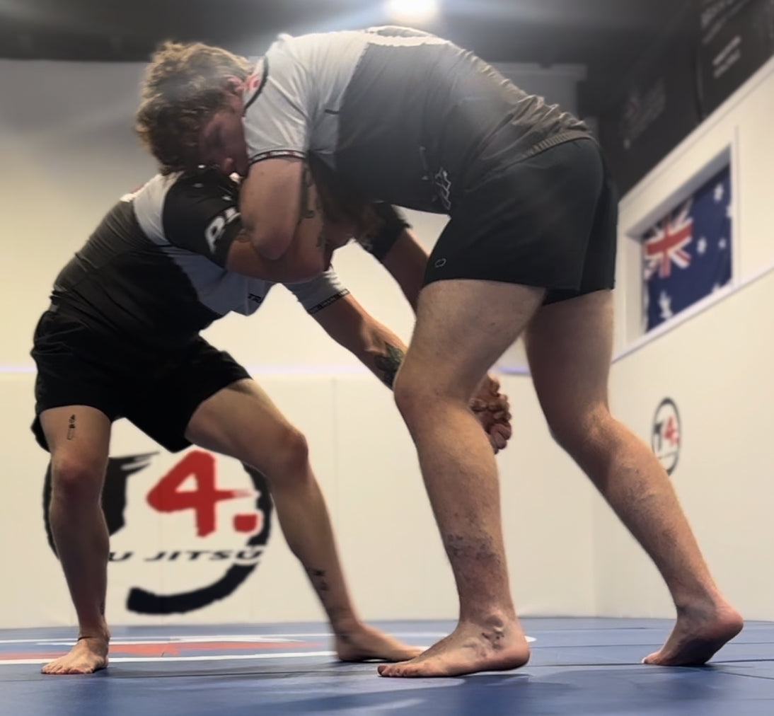 Two NoGi training partners practising standing grips at Train4